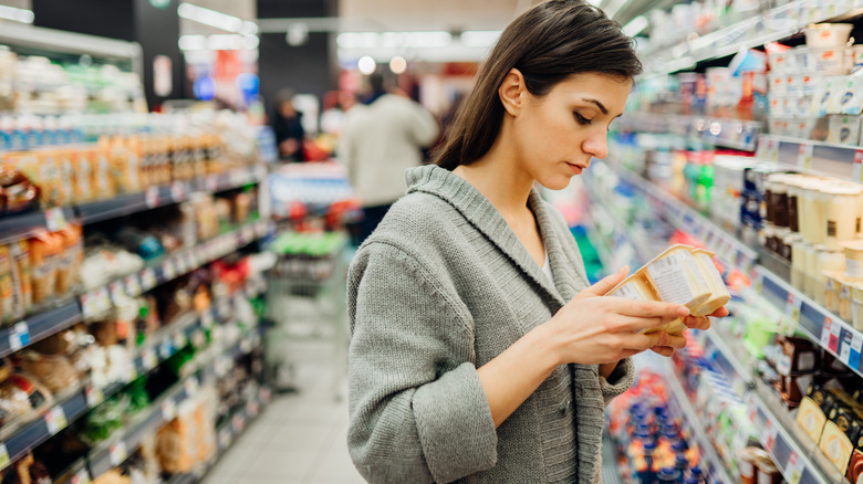 person shopping in supermarket aisle