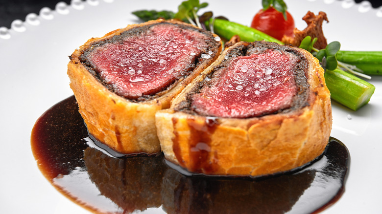 beef wellington served on sauce with garnishes