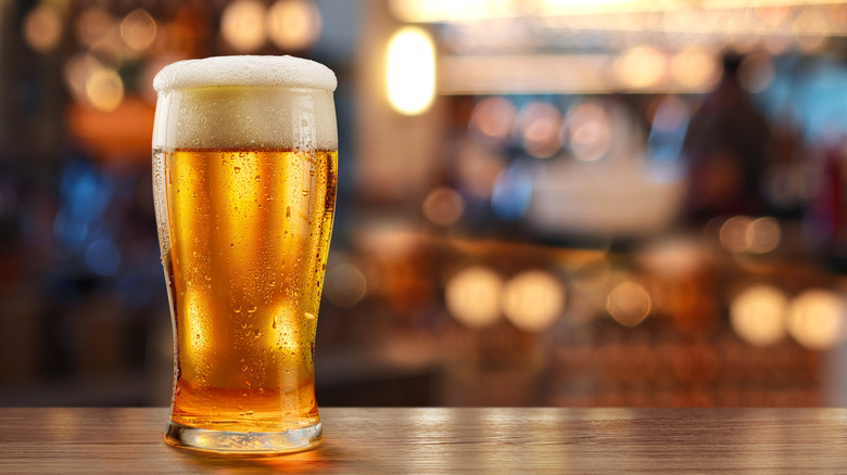 A glass of beer on a wooden tabletop