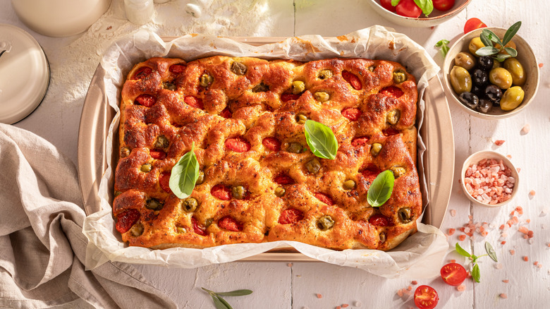 Focaccia stuffed with tomatoes and olive oil and topped with basil.