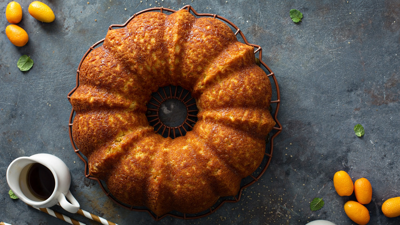 Golden pound cake on round wire Bundt cake rack