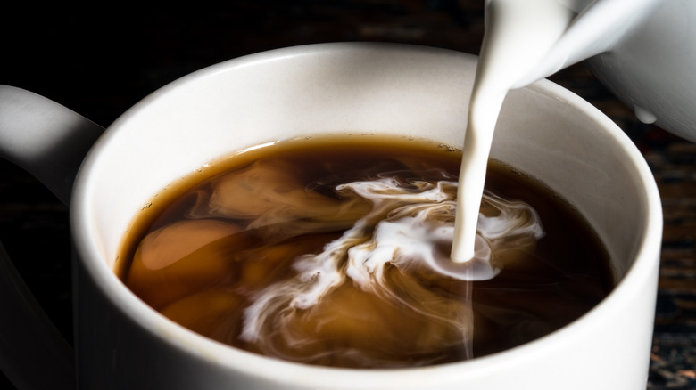 Creamer being poured into coffee