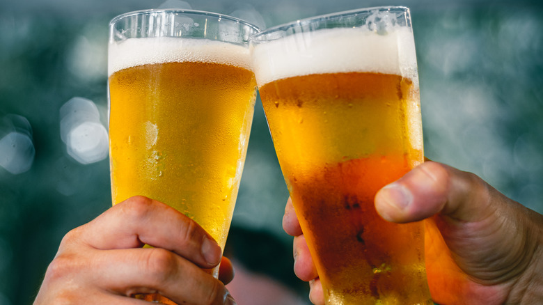 toasting with two glasses of beer