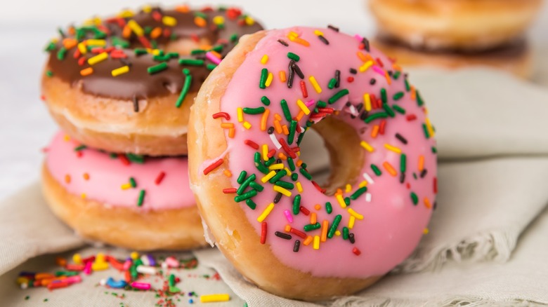 Pink and chocolate donuts with rainbow sprinkles