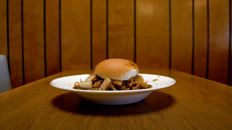 Chow Mein Sandwich in front of wood paneling