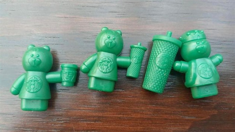 Small green bear drink stoppers inside Starbucks Rosca de Reyes pastry