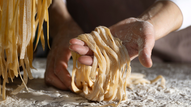 Pasta being prepared by hand.