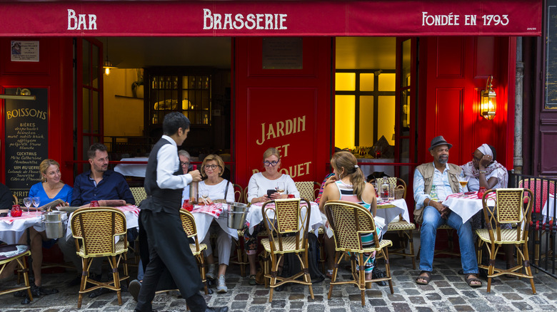 French brasserie with people sitting at sidewalk tables
