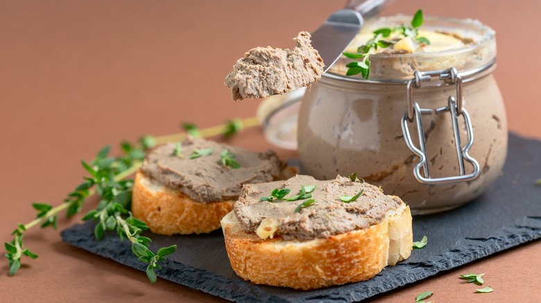Jar of pate and pate spread on bread