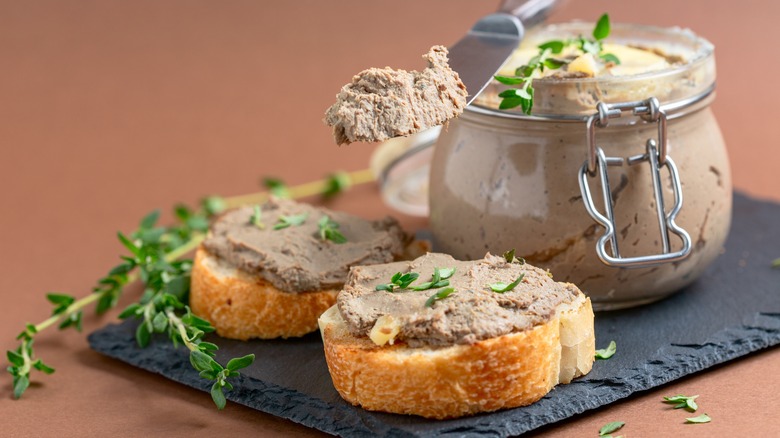 Jar of pate and pate spread on bread