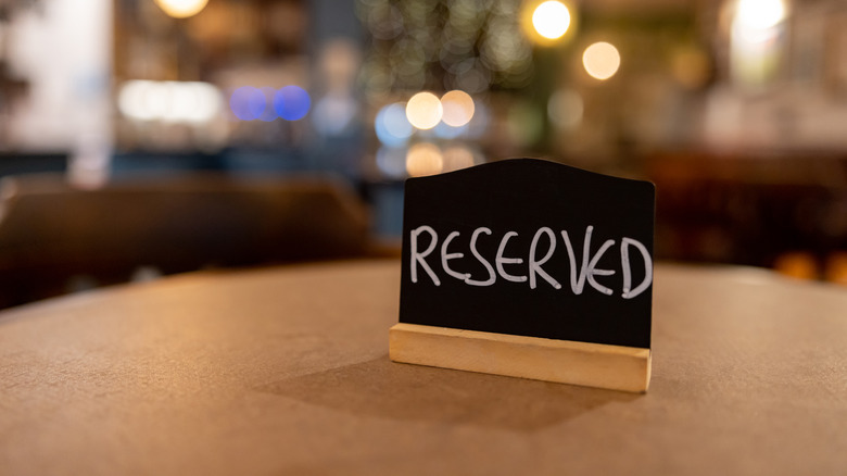 "Reserved" place card on table