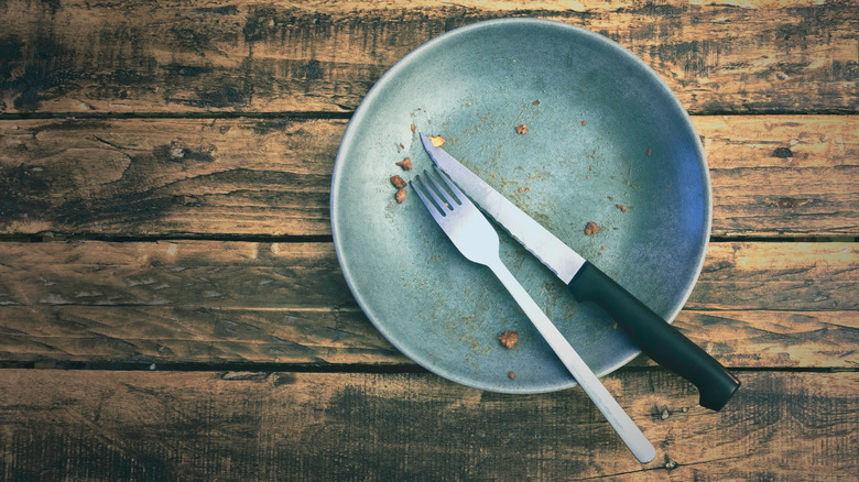 knife and fork on finished plate