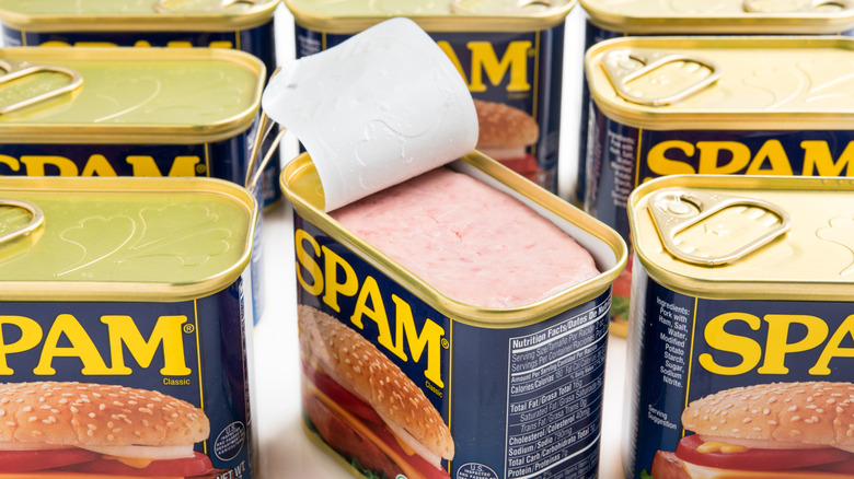 SPAM cans with one opened showing pink pork meat inside