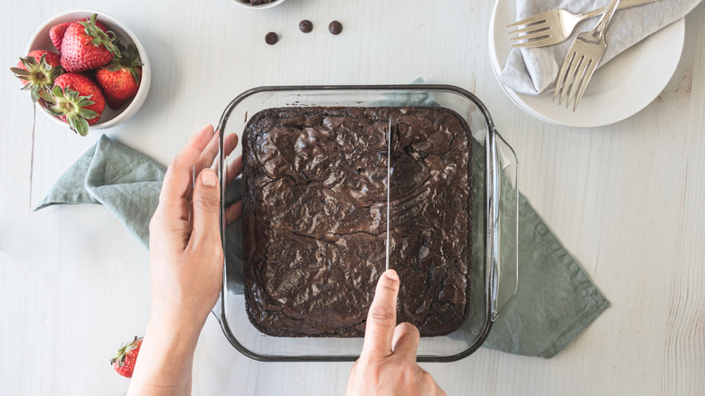 Woman cutting brownies