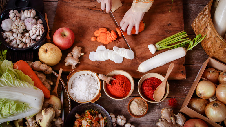 Someone preparing vegetables for fermentation