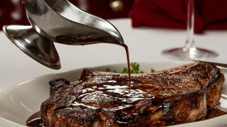 Sauce poured over a steak at the Golden Steer