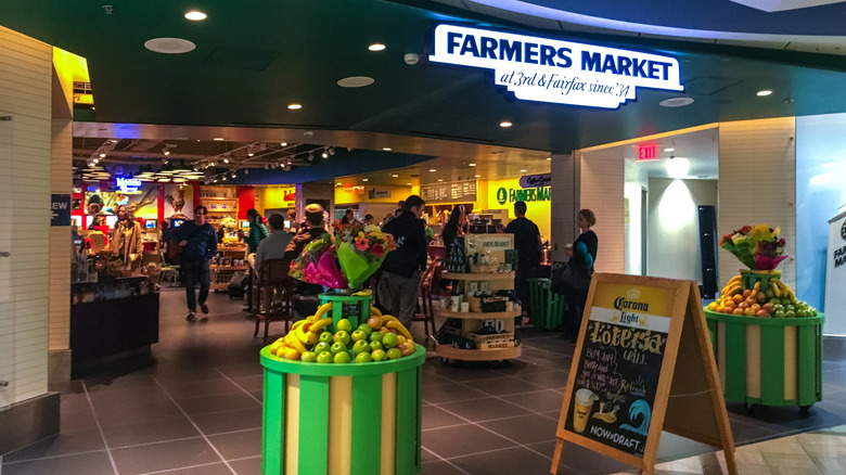 Farmers Market stall in LAX, full of people shopping and fresh foods