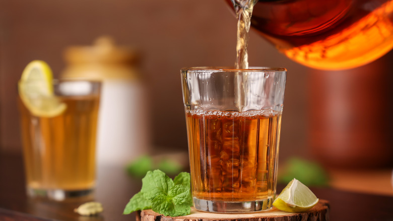 Tea being poured in a glass