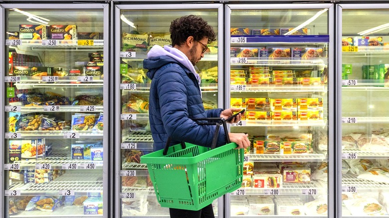 Grocery shopper searching frozen food aisle