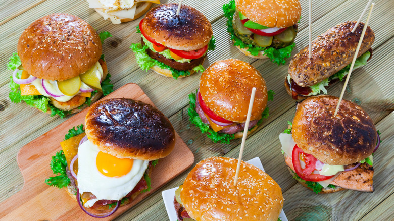 Various burgers on a table.