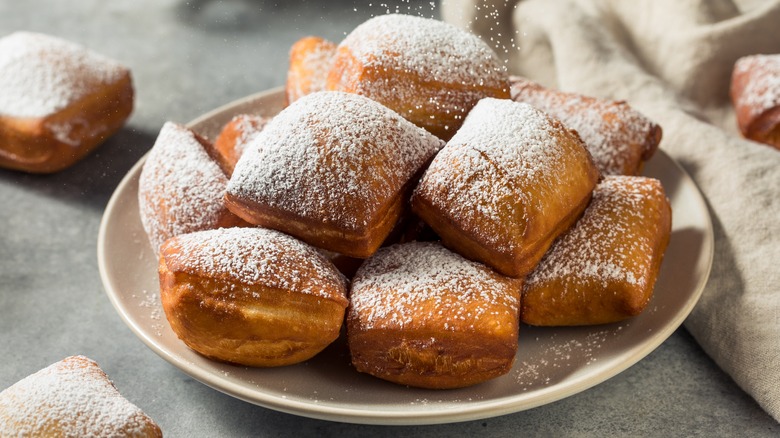 Plate of beignets with powdered sugar