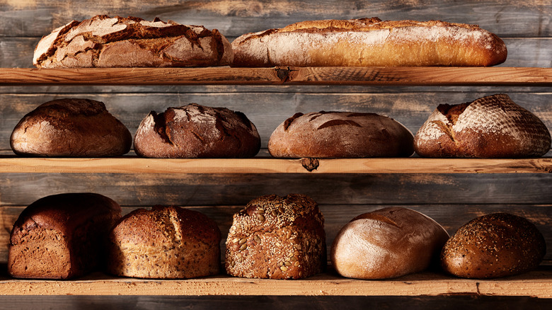 loaves of bread on a wooden shelf