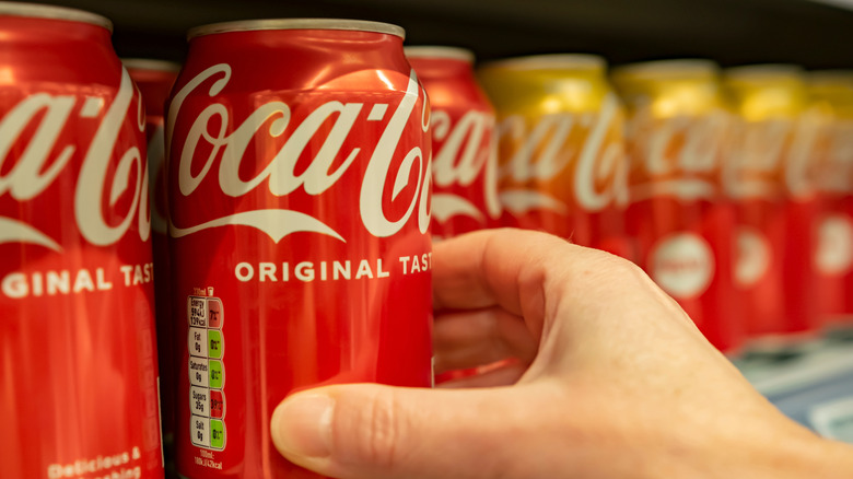 Grabbing a Coca-Cola can off the shelf