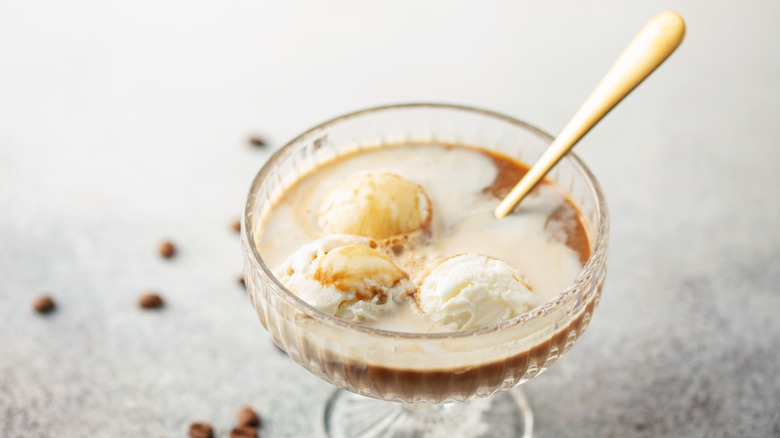Vanilla ice cream and espresso Affogato with a spoon in a coupe glass