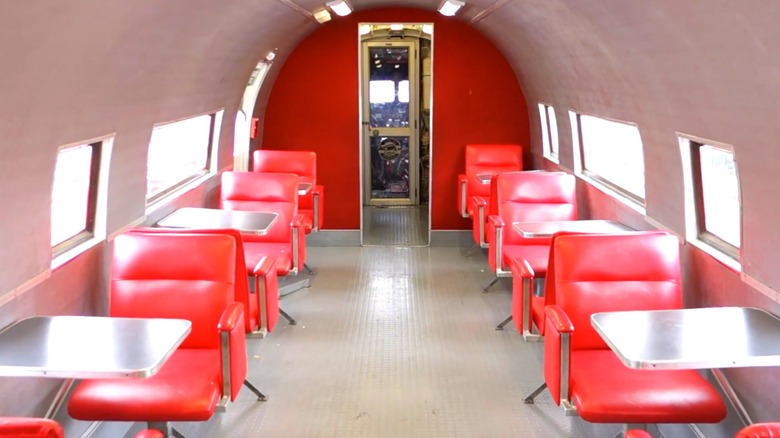 Interior shot of the red booths and chairs lining the McDonald's-branded aircraft.
