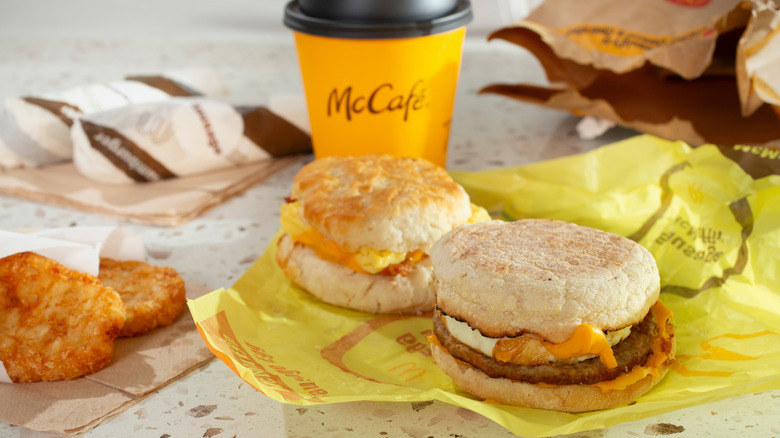 Two McDonald's breakfast sandwiches, hashbrowns, and a coffee