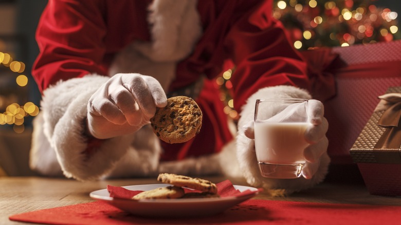 Santa enjoying chocolate chip cookies and milk