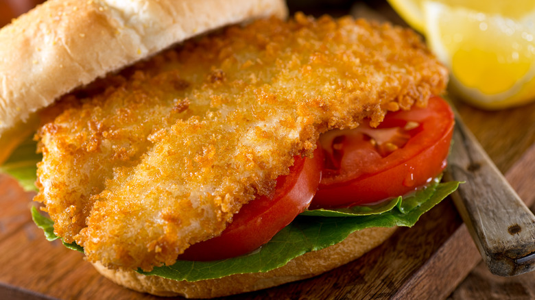 An open fried fish sandwich.