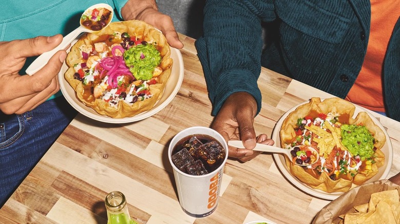 Diners eating taco bowls at a Qdoba