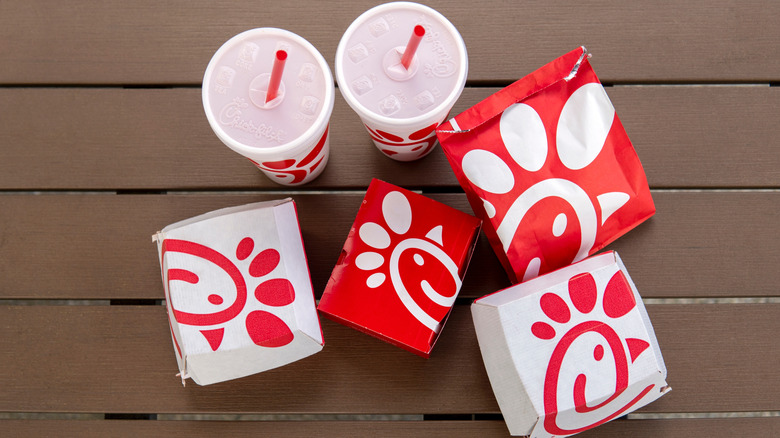 Arial shot of Chick-fil-A sandwich boxes and bags and two drink cups.