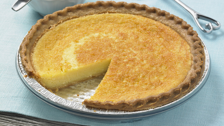 A lemon Shaker pie with one slice removed