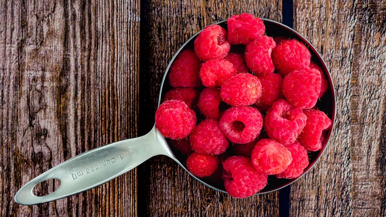 Raspberries in measuring cup
