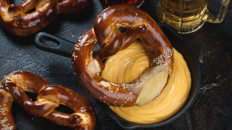 Beer cheese and pretzel in cast-iron dish