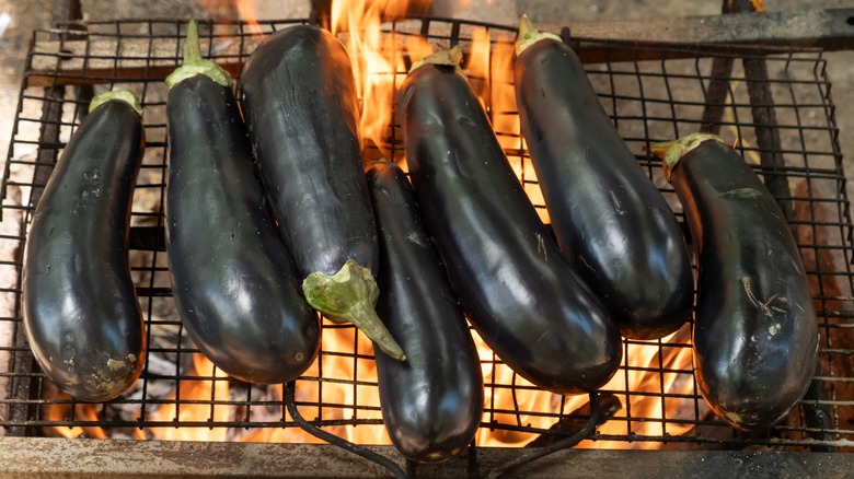 Eggplants roasting over open flames