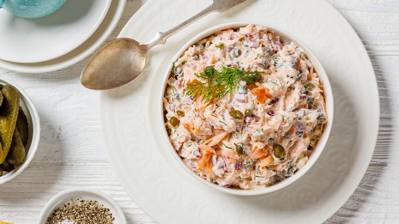 Smoked salmon dip on white plate with spoon