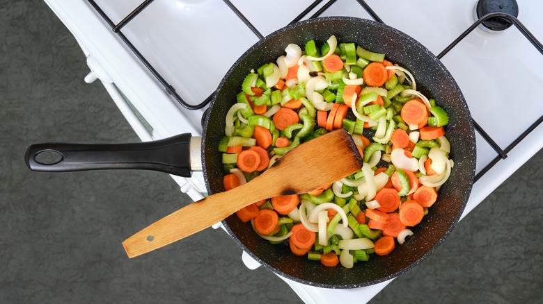 Skillet full of chopped carrots, onions, and celery