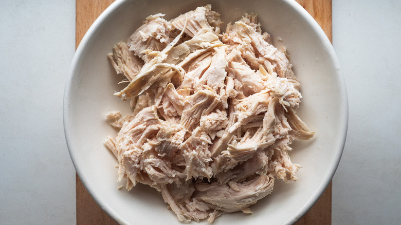 Shredded chicken in white bowl