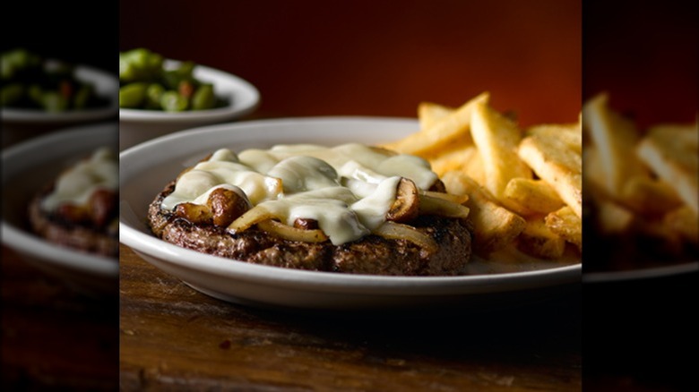 Texas Roadhouse road kill steak topped with cheese and mushrooms