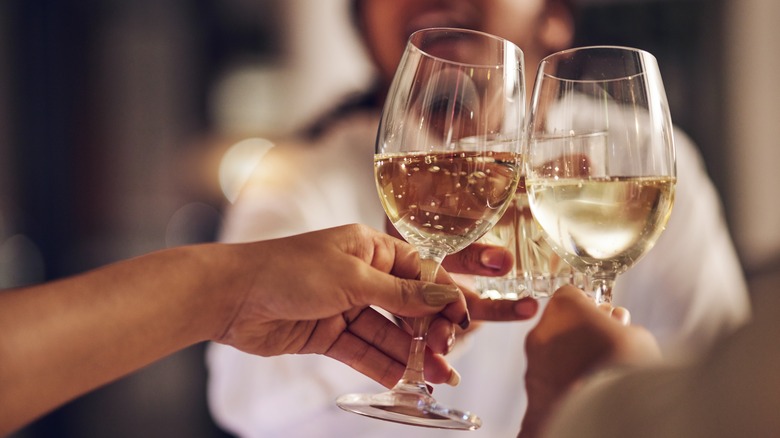 people cheersing with sparkling wine