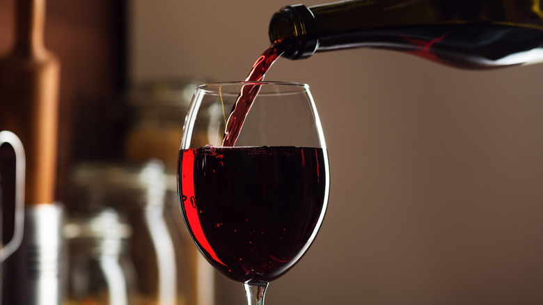 red wine being poured into a glass
