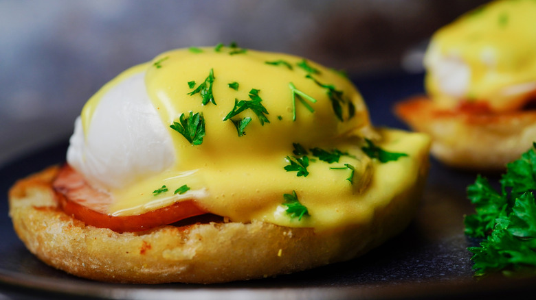 eggs benedict with parsley sprinkled on top
