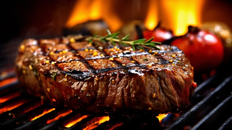 Steak cooking on a grill