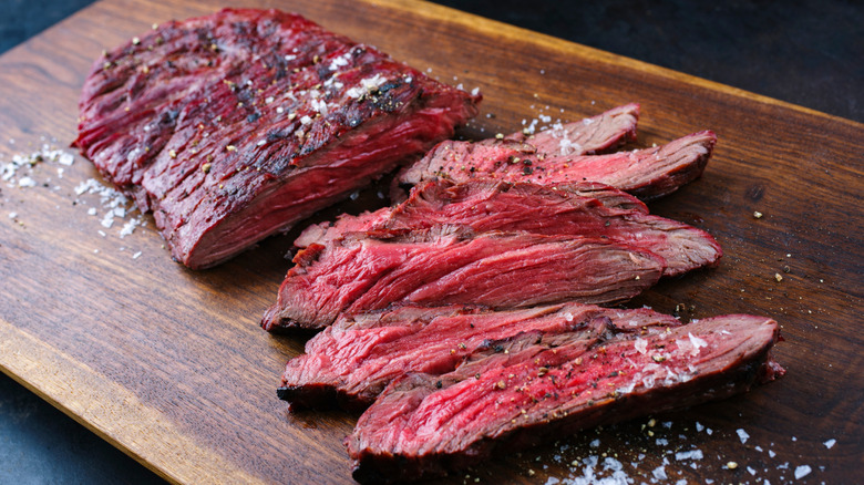 Sliced bavette steak on wooden board