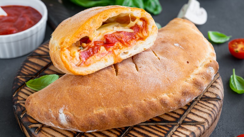 Calzones sliced with cheese and tomato sauce inside
