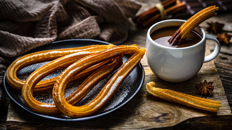 plate of churros mug hot chocolate