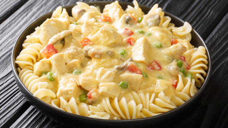 Chicken &agrave; la king served over pasta